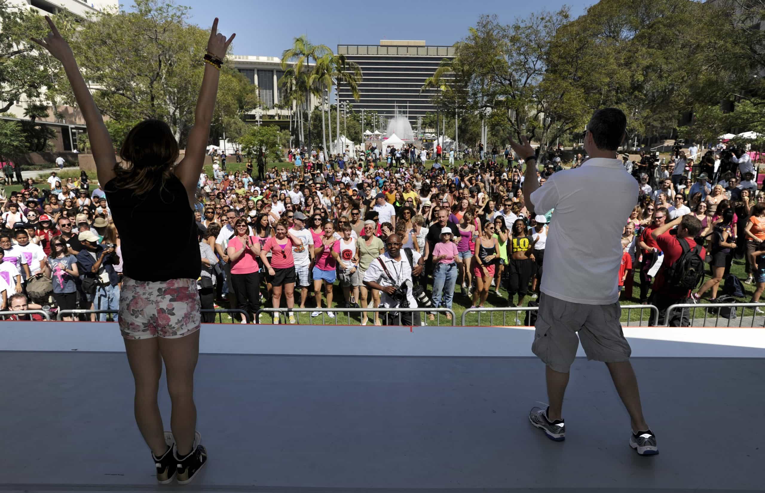 Image of two people standing in front of a crowd